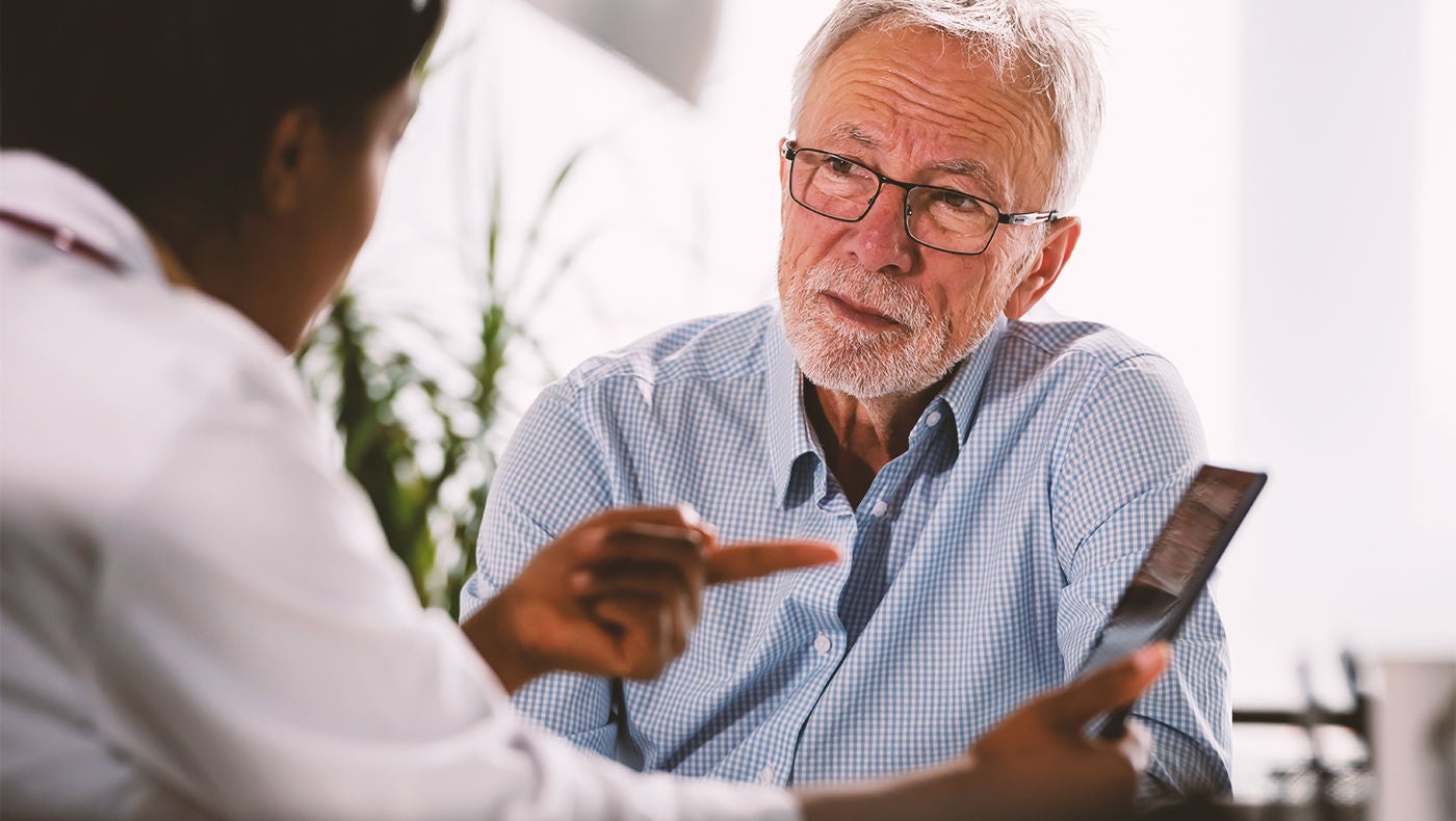 Arzt erklärt männlichem Patienten gutartige Prostatavergrößerung
